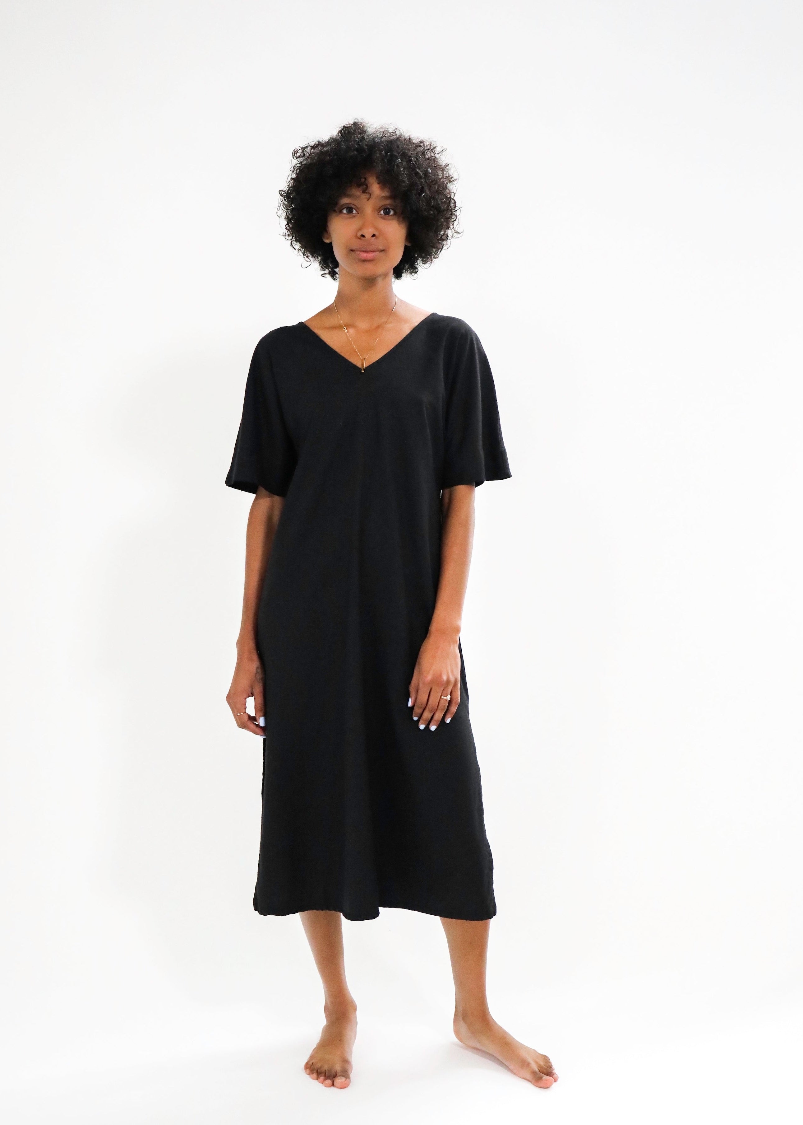 Woman wearing a black dress on a white background