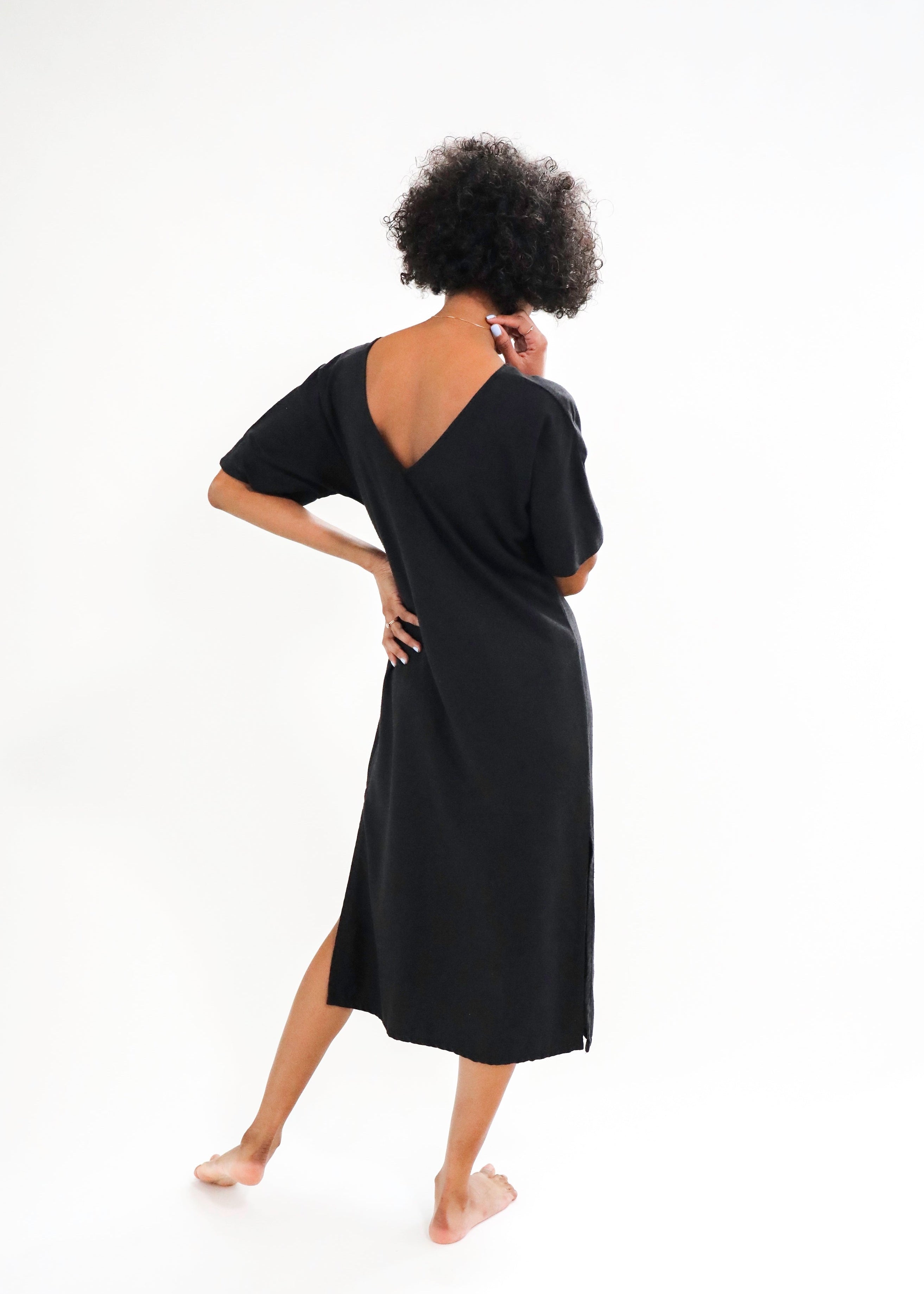 Person wearing a black dress on a white background