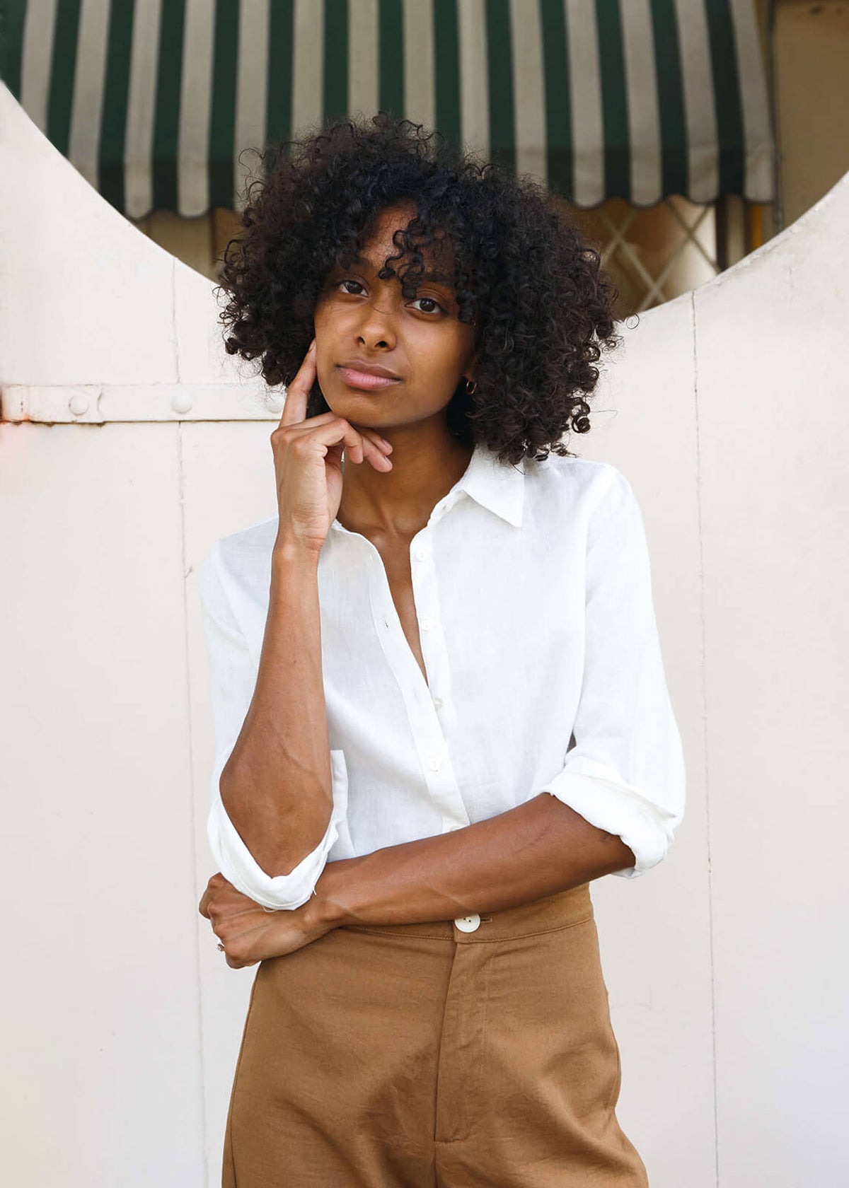 woman wearing a linen white button up shirt.